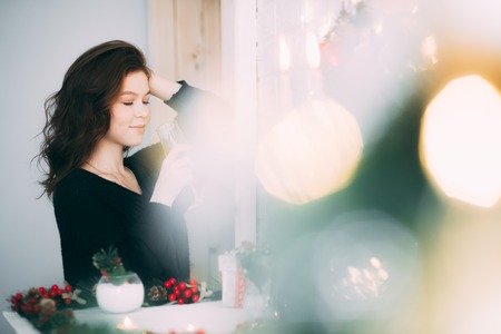 Beautiful girl with a glass of champagne, Christmas atmosphere, new yearの写真素材