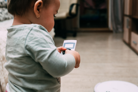 The child controls the robot with a remote vacuum cleanerの写真素材