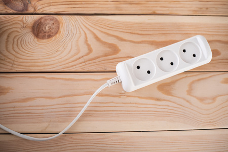 socket on wooden background white with wire