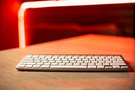 White keyboard with mouse on beautiful glowing red background