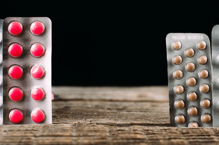 tablets on a wooden table between them black background standing place for insertion, copy space