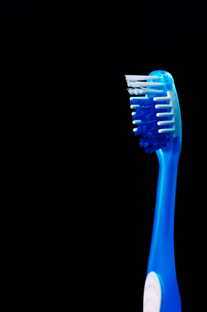 Macro shot of a toothbrush against a black background with copy space.の写真素材