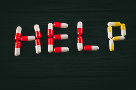 Word HELP made of pills on dark background. Suicide awareness conceptの写真素材