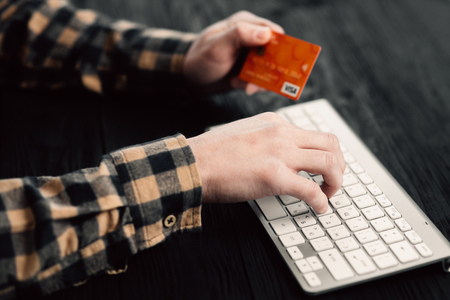 Hands using computer and credit card. Online shoppingの写真素材