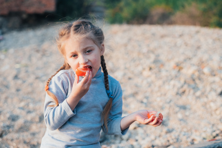 the girl in the sea eats tomato and building facesの写真素材