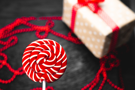 red, round colored Lollipop on black background sweetの写真素材
