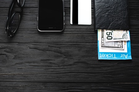 On the wooden black table tickets are your passport and credit card points the concept of travel