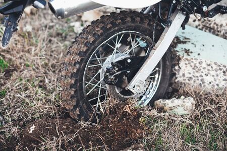 Action the wheel of an Enduro Motorcycle Hits an obstacle in the ground, dirtの写真素材