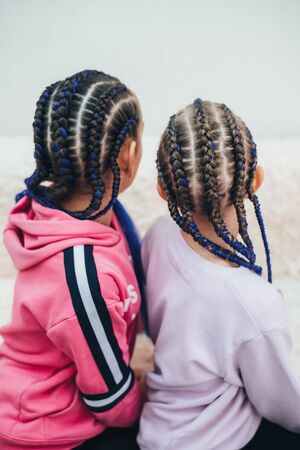 Braids with artificial material woven beautifully and fashionably, on a little girl cool