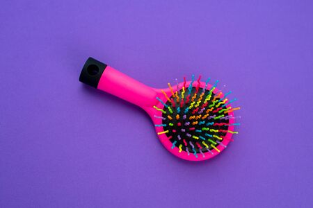 Children's round comb on a purple background, colorの写真素材