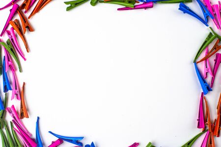 many multi- colored hair clips in the form of a frame , in the middle of the white background for the inscription coolの写真素材
