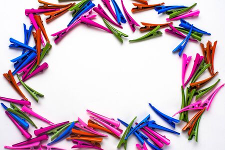 many multi- colored hair clips in the form of a frame , in the middle of the white background for the inscription coolの写真素材