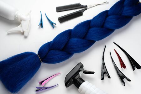 Kanekalon artificial blue hair for braiding and Afro hairstyles , lying on a white background next to accessoriesの写真素材