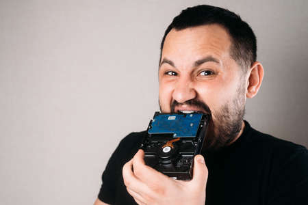 The man bites the hard drive trying to breakの写真素材
