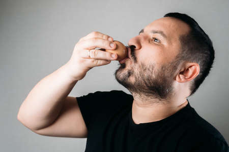 a man drinks a raw eggの写真素材