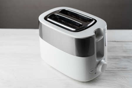 White with silver toaster on gray background