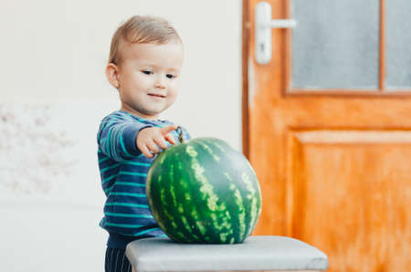 A little boy enjoys watermelonの写真素材