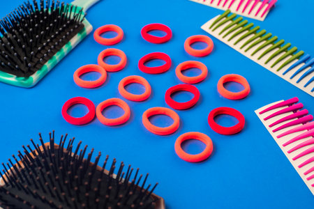 on a blue background are combs hair clips elastic bands, hairdressing accessories
