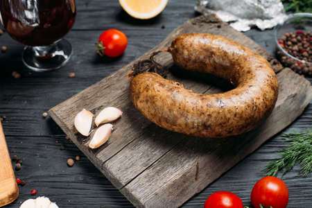 smoked homemade sausage on a wooden background and an old wooden hot smoked sausageの写真素材