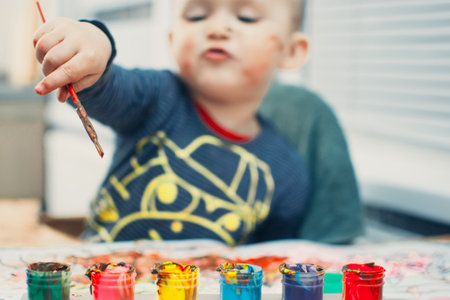 Happy cute kid paint gouache paints mixedの写真素材