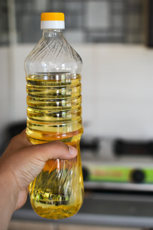 A bottle of vegetable oil on the table in the kitchen isの写真素材