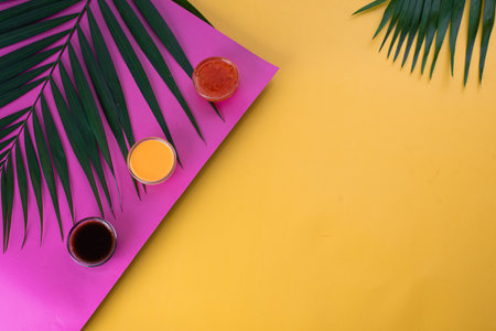 A vibrant tropical background featuring colorful shades of turquoise, pink, and yellow with large...