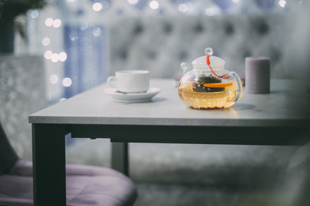 A minimalist tea set with a glass teapot on a caf table, ready to enjoy.の写真素材