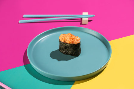 A single seaweed-wrapped roll topped with fresh avocadoの写真素材