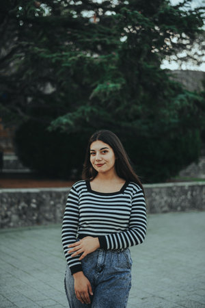 A stylish woman relaxing in the middle of a busy city day.の写真素材