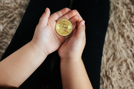 Palm of a Child Holding Bitcoin, Gateway to Financial Literacy