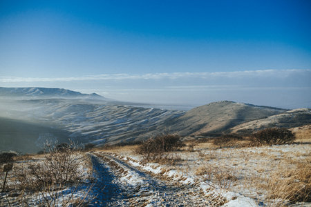 A snowy mountain range with a clear blue skyの写真素材