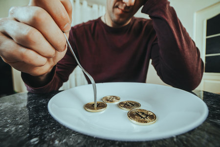 Man hand holding fork skewering a coin over a plate full of dollar bills, symbolizing the...