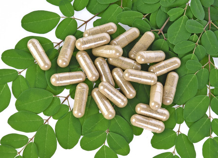 Herbal capsules with leaf  on white backgroundの写真素材