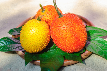 Fresh Gac fruit in the wooden dishの写真素材