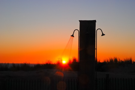 Sunbathing Concept with backlit open air shower at the beach with view over the oceanの写真素材