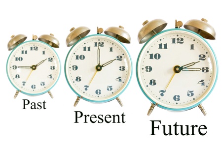 three different clocks showing different times representing past present future; time conceptの写真素材
