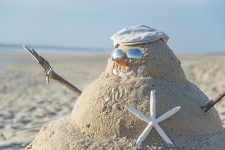 Snowman On Beach with shells as mouth and sun glassesの写真素材
