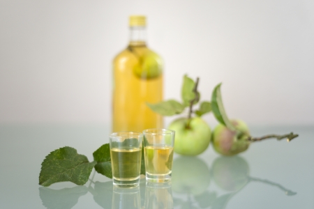 Apple inside bottle filled with liqeur, schnapps or Obstwasserの写真素材