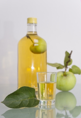 Apple inside bottle filled with liqeur, schnapps or Obstwasserの写真素材