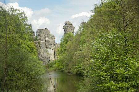 The Externsteine sandstone rockformation with Wiembecke pond in the Teutoburg Forest Horn-Bad Meinberg, Germanyの写真素材