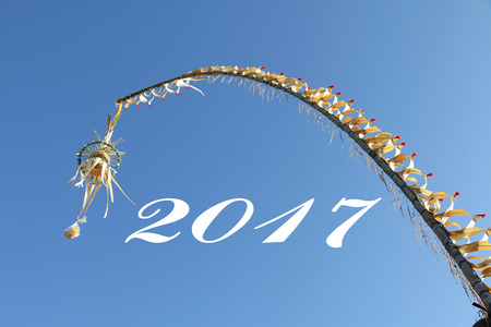 Bali street decoration called Penjor with Blue sky background and number - 2017