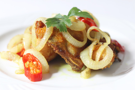 Fried chicken with turmeric, onion and chiliの写真素材