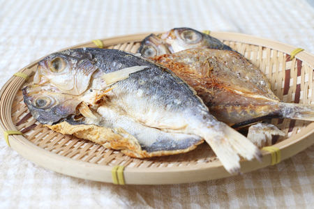 Raw dried salted fish on bamboo trayの写真素材