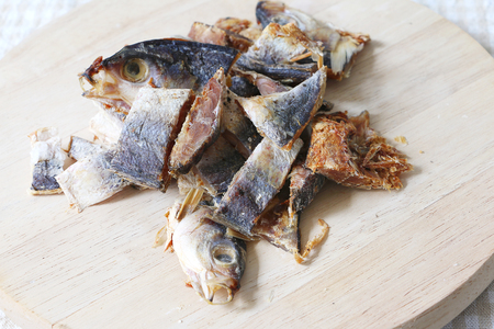 Cutted salted fish on wooden chopping boardの写真素材