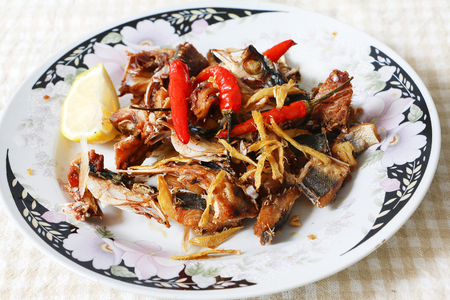 Fried salted fish with ginger and chilli pepperの写真素材