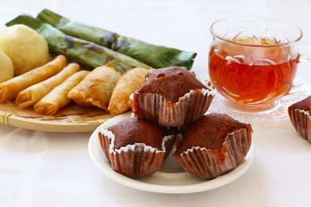 Close-up shot of Malaysia and Indonesia traditional cakes, dessert served with hot tea on white backgroundの写真素材