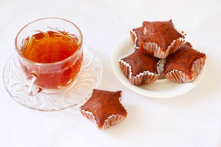 Caramel cup cake. Star shape cup cake served with tea on white backgroundの写真素材