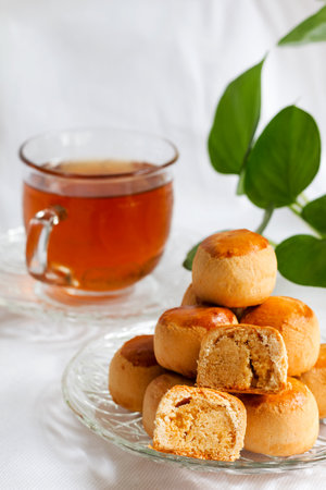 Chinese traditional cookies 'Biscuit Tambun' served with cup of teaの写真素材