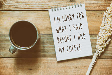 Flat lay of coffee and note pad with quotes - I'm sorry for what i said before i had my coffeeの写真素材