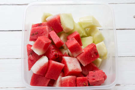 Cut Watermelon and honeydew on white wooden table backgroundの写真素材